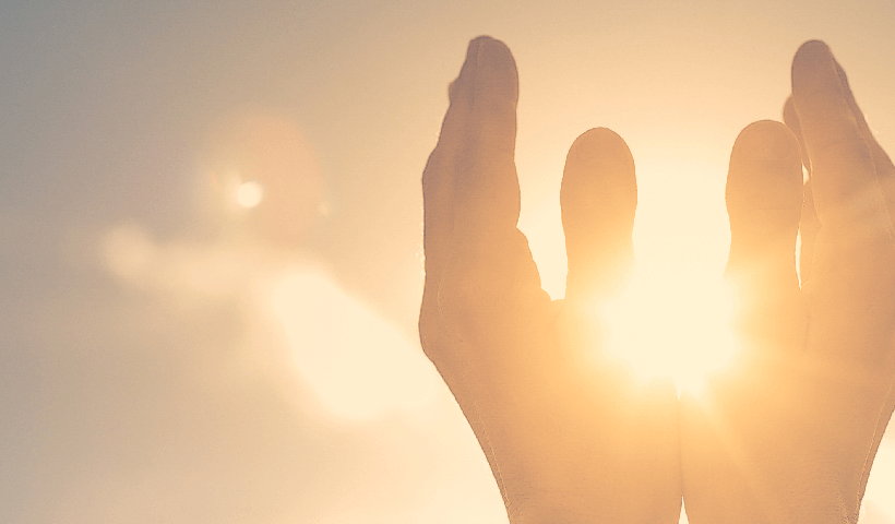 Hands raised welcoming the sun rise